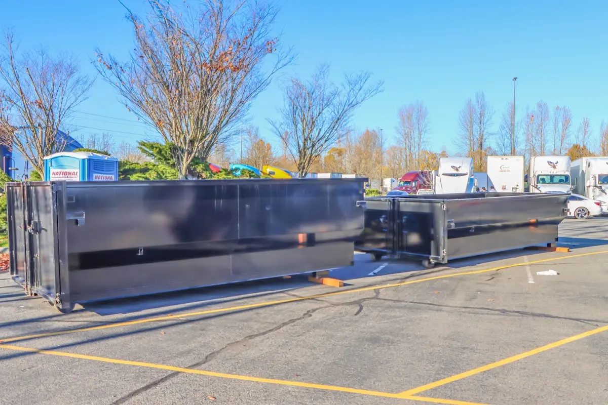 Professional dumpster rental service with roll-off container on residential driveway in Bowling Green